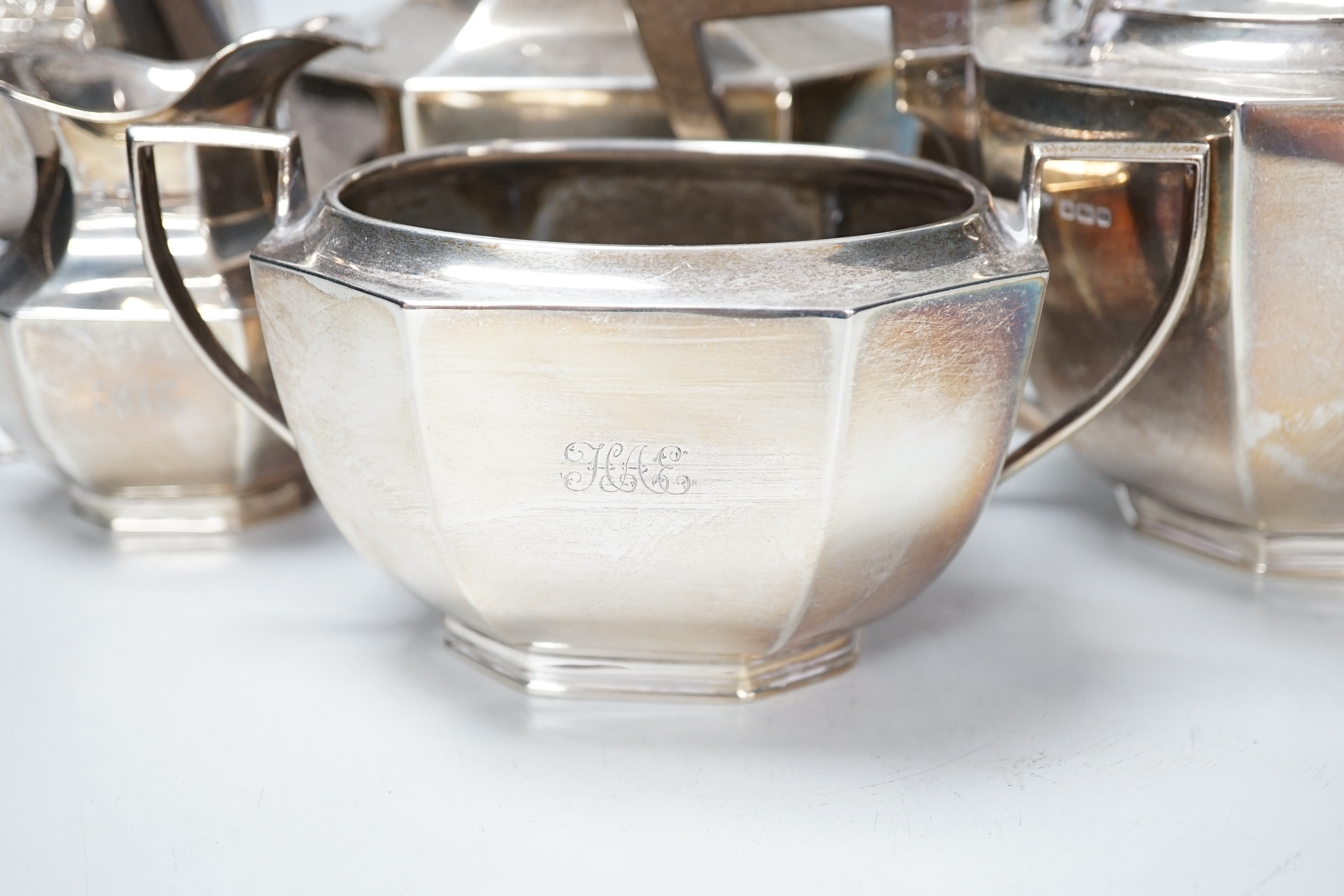 A George V panelled silver four piece tea and coffee service, Fordham & Faulkner, Sheffield, 1911 and a similar hot water pot, Hawksworth, Eyre & Co Ltd, London, 1912, gross weight 79.3oz.